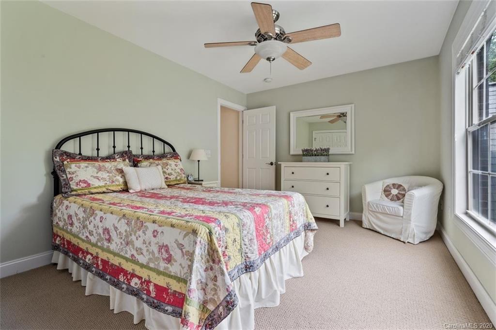 142 Spring Branch Road Fort Mill, SC 29715 - Photo 26 of 48 a bedroom with a bed and a chandelier
