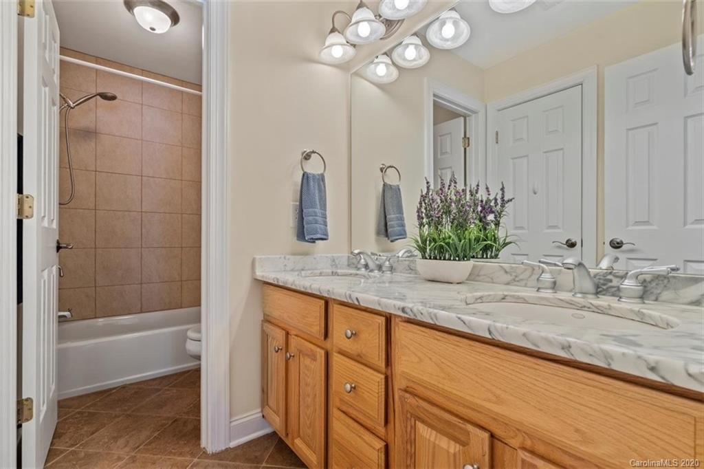 142 Spring Branch Road Fort Mill, SC 29715 - Photo 29 of 48 a bathroom with a granite countertop sink a mirror and a bathtub