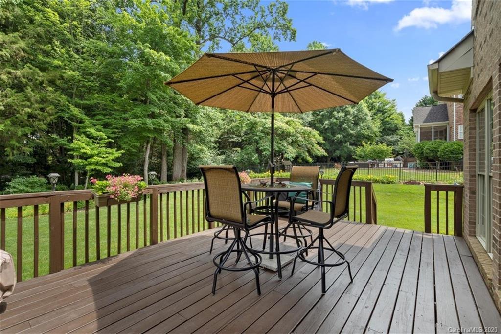 142 Spring Branch Road Fort Mill, SC 29715 - Photo 33 of 48 a view of deck with dinning table and chair under an umbrella with wooden floor
