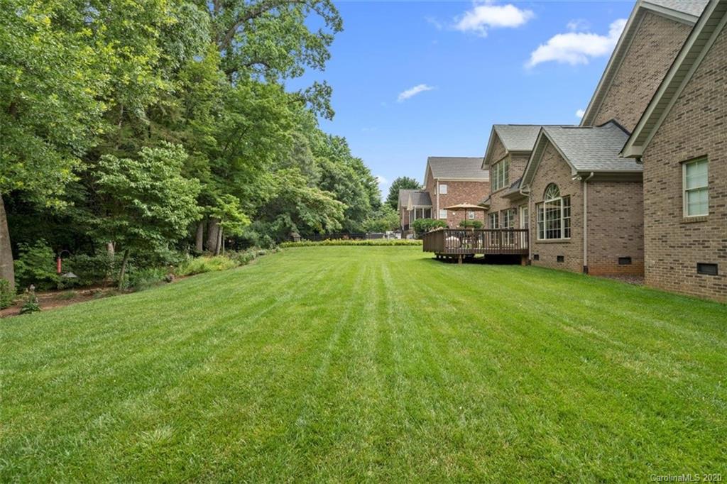 142 Spring Branch Road Fort Mill, SC 29715 - Photo 35 of 48 a view of a big house with a big yard and large trees