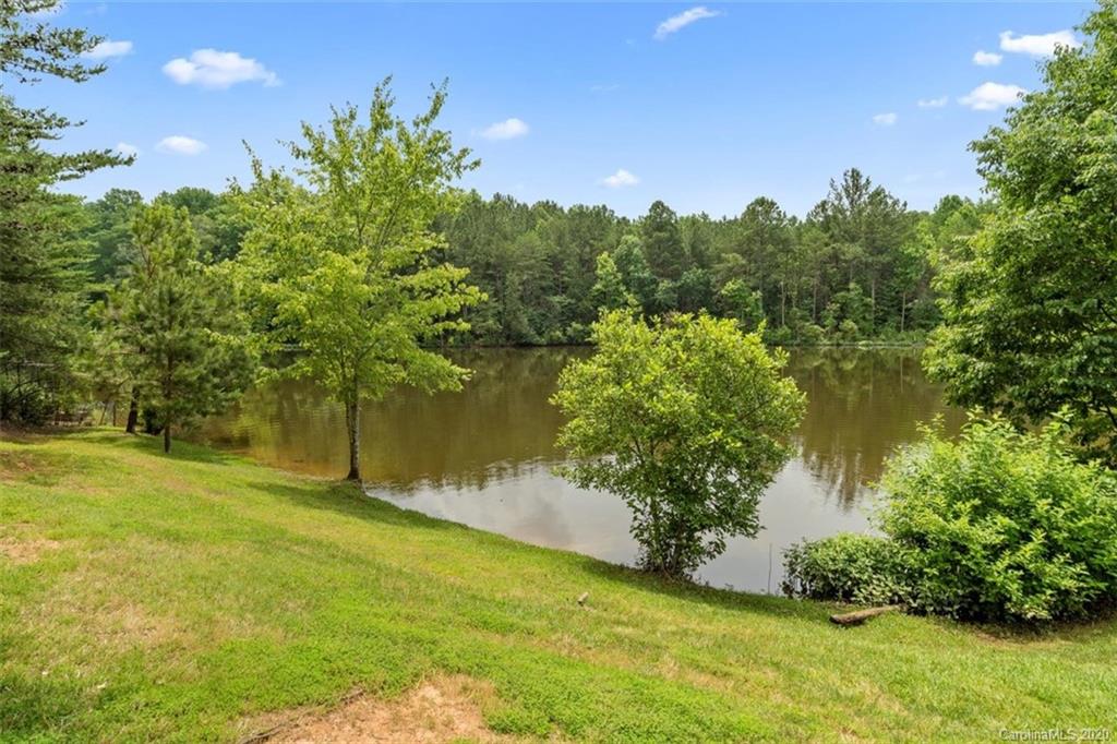 142 Spring Branch Road Fort Mill, SC 29715 - Photo 42 of 48 a view of a lake with a yard