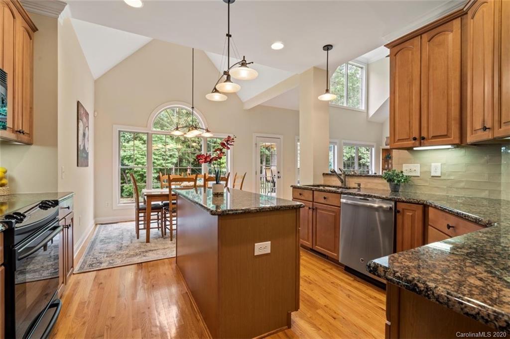 142 Spring Branch Road Fort Mill, SC 29715 - Photo 9 of 48 a kitchen with granite countertop a stove a sink a refrigerator and a wooden floor