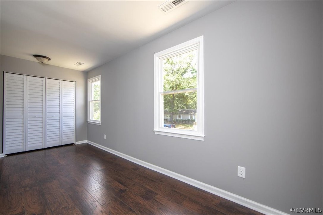 9301 Telstar Drive Richmond, VA 23237 - Photo 20 of 24 an empty room with wooden floor and windows