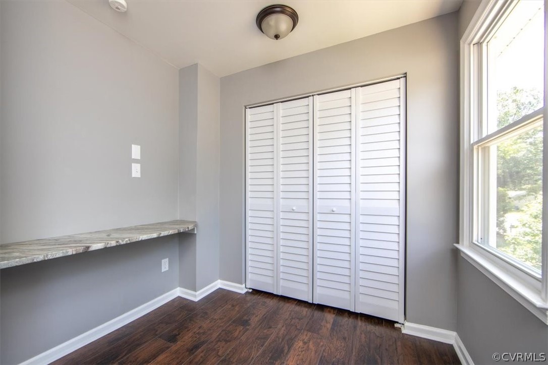 9301 Telstar Drive Richmond, VA 23237 - Photo 22 of 24 an empty room with wooden floor and windows