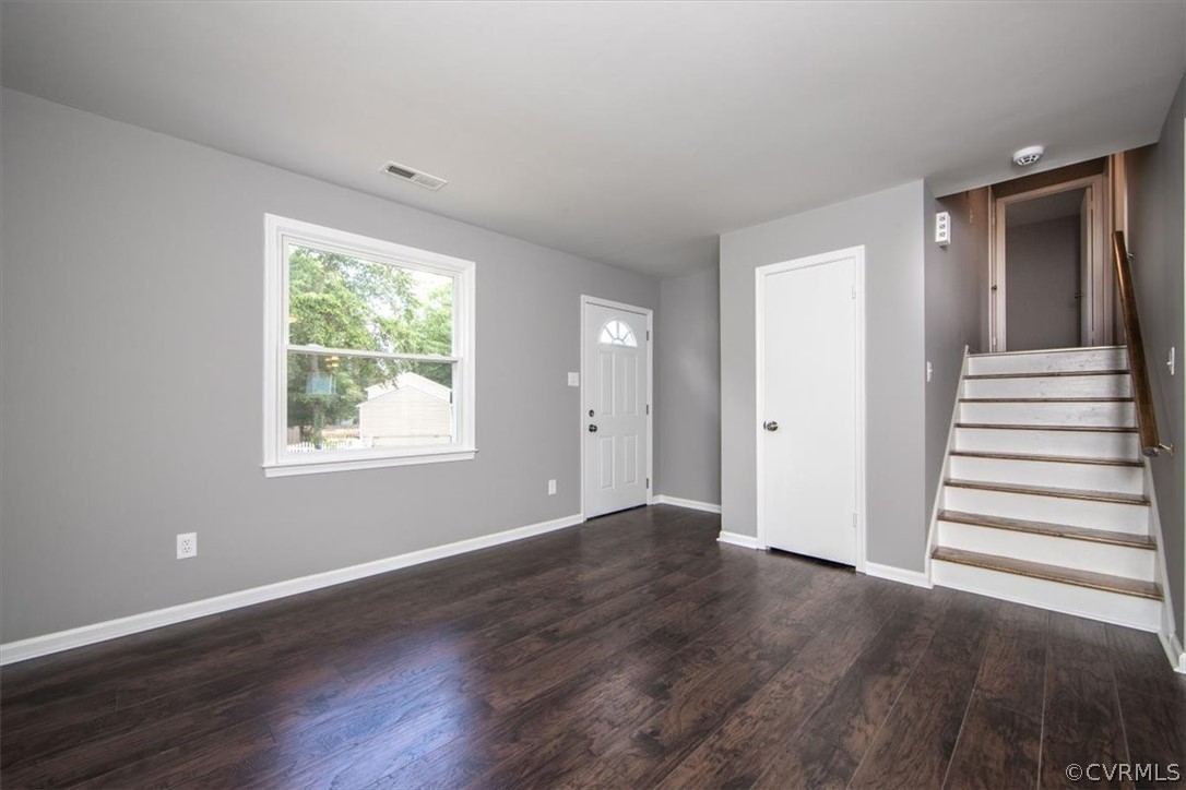 9301 Telstar Drive Richmond, VA 23237 - Photo 4 of 24 an empty room with wooden floor and windows