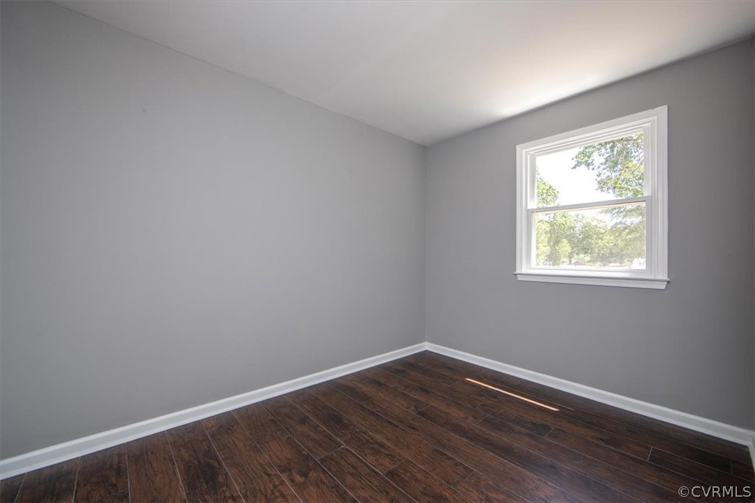 9301 Telstar Drive Richmond, VA 23237 - Photo 9 of 24 a view of an empty room with wooden floor and a window
