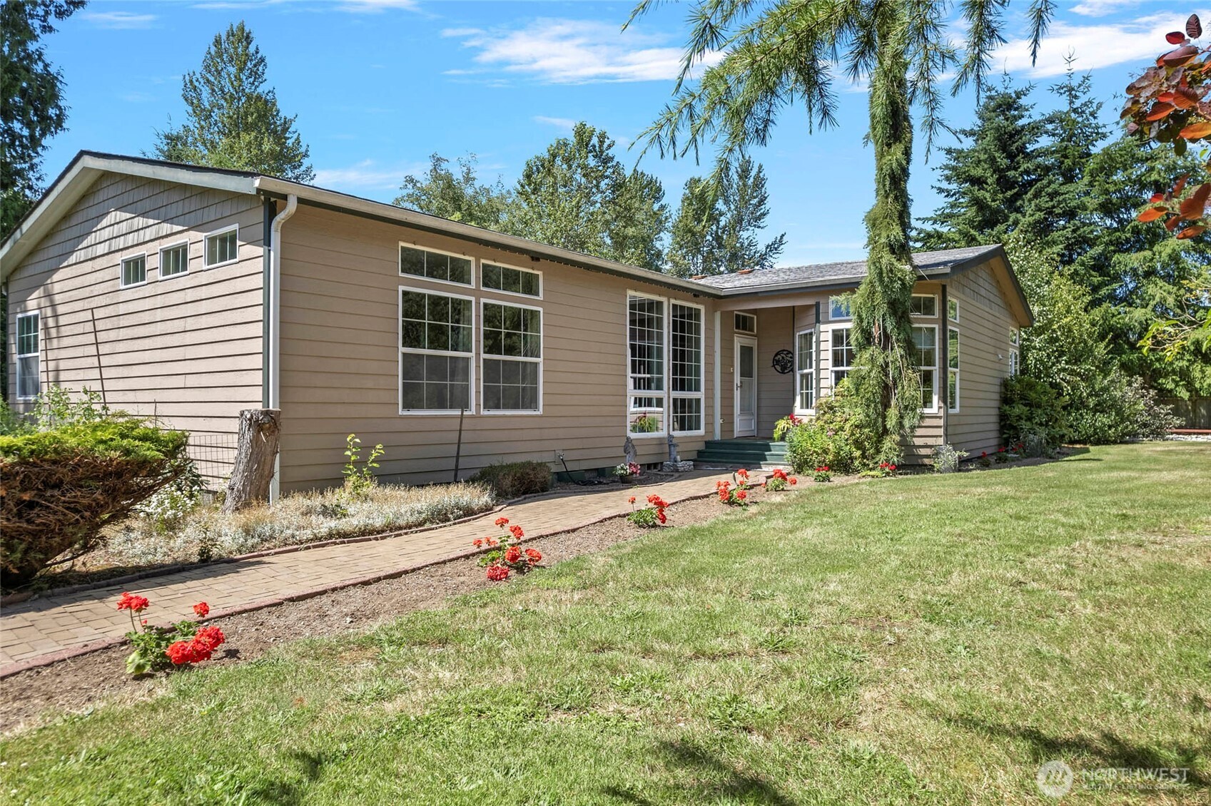 front view of house with a yard and potted plants
