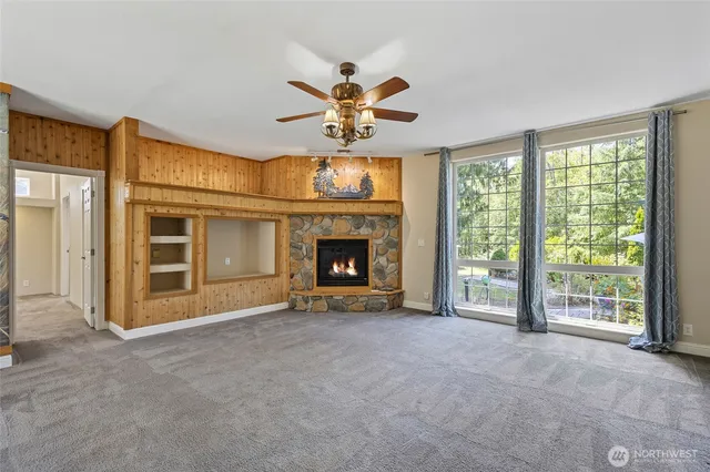 a view of an empty room with a fireplace and a window