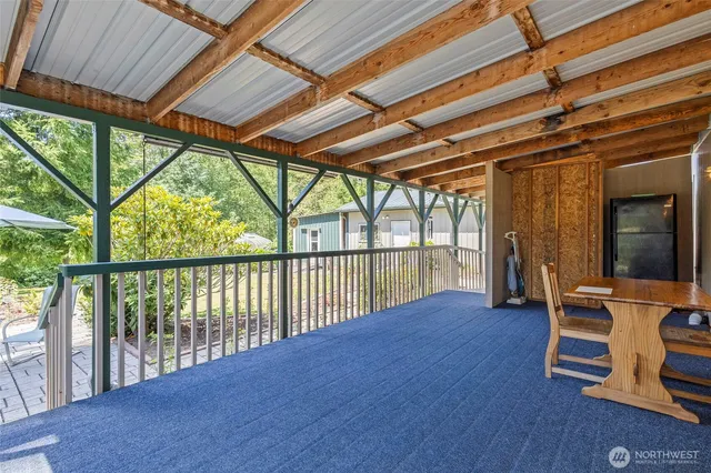 a view of porch with furniture and wooden floor