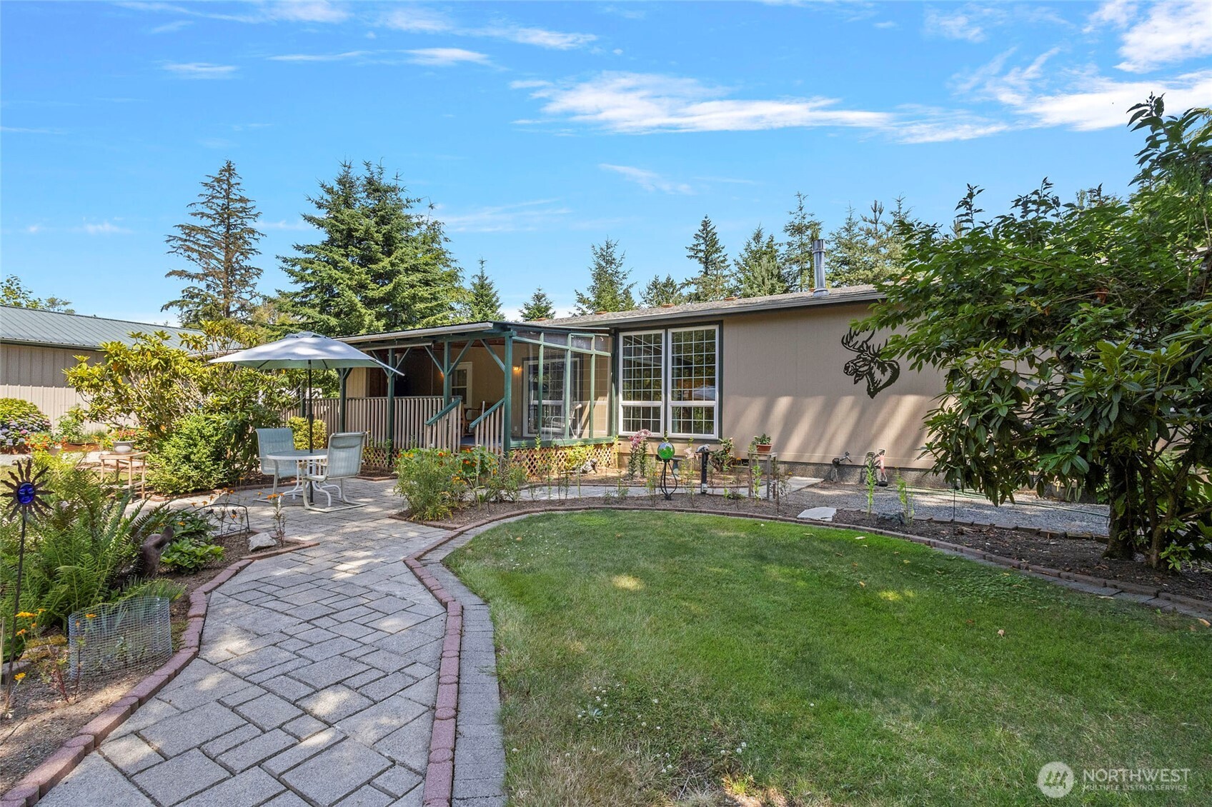 6948 Howell Lane Sedro-Woolley, WA 98284 - Photo 29 of 40 a view of a house with backyard sitting area and garden