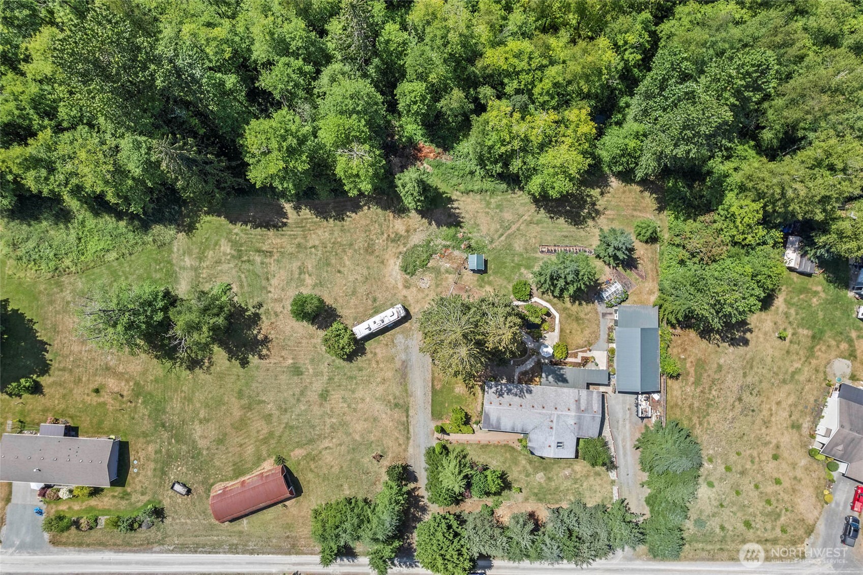 6948 Howell Lane Sedro-Woolley, WA 98284 - Photo 39 of 40 an aerial view of a house with a yard lake and trees all around