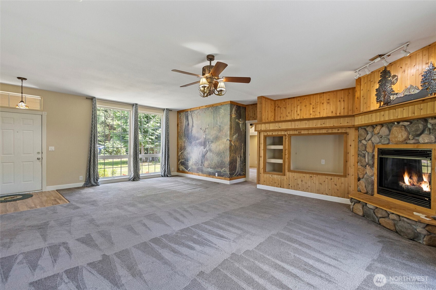 6948 Howell Lane Sedro-Woolley, WA 98284 - Photo 4 of 40 a view of an empty room with a fireplace and a window