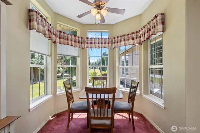 a view of a dining room with furniture a chandelier and wooden floor