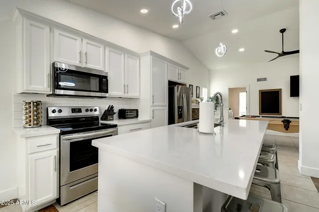 a view of a dining room and kitchen with a table chairs a sink and dishwasher