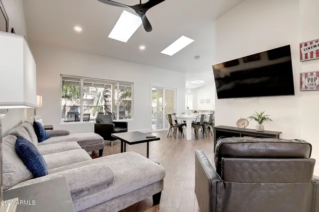 a living room with furniture and a wooden floor