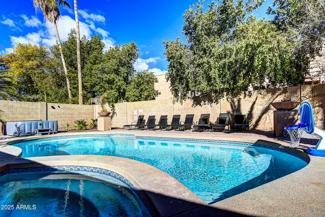 a view of a swimming pool with an outdoor seating