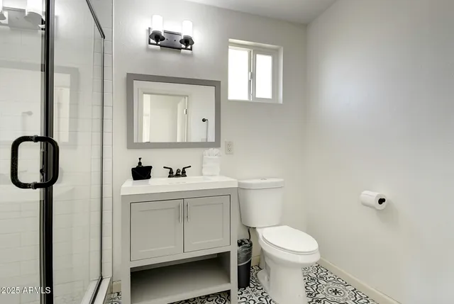 a bathroom with a toilet sink and mirror