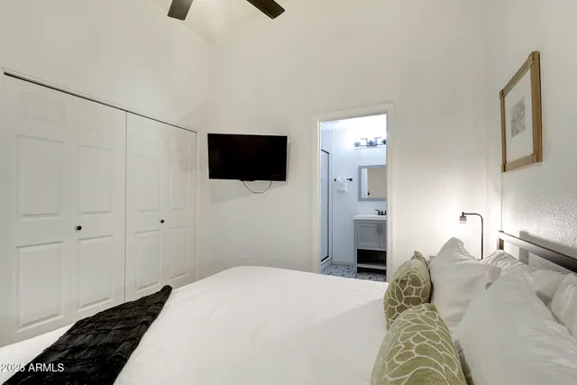 a bedroom with a bed and a chandelier