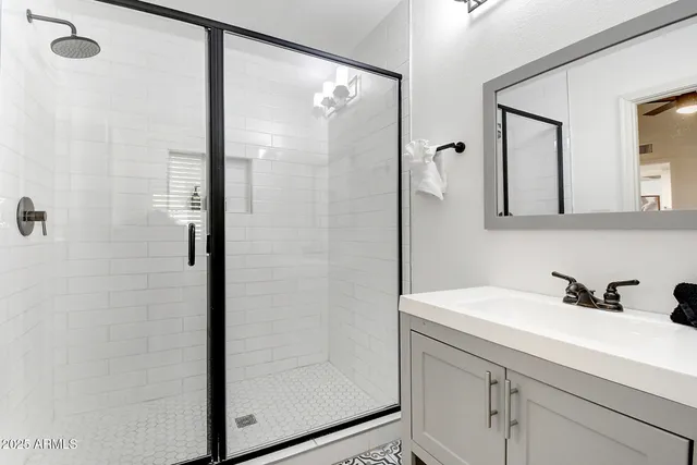 a bedroom with a bed and a large mirror