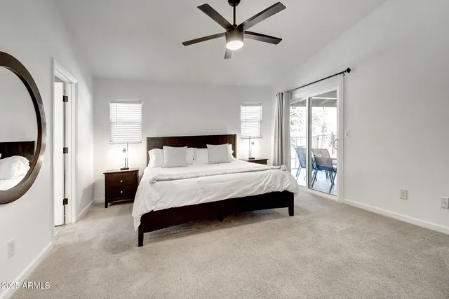 a bathroom with a granite countertop double vanity sink a mirror and a toilet