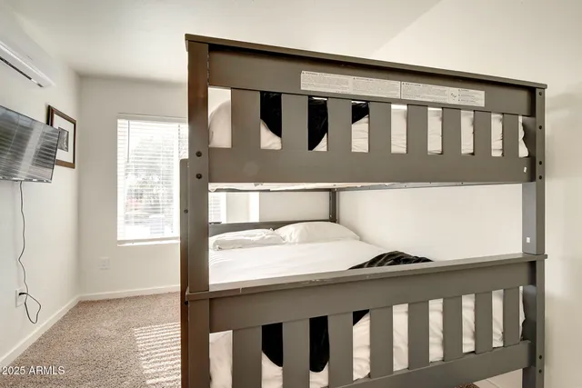 a bedroom with a bed and a lamp