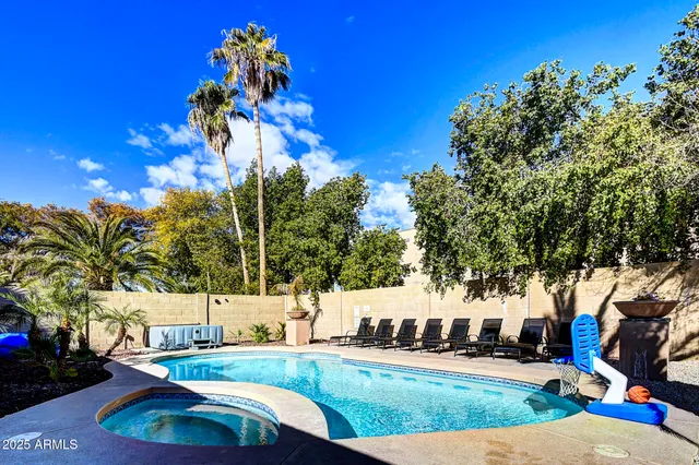 a front view of a house with a yard and potted plants