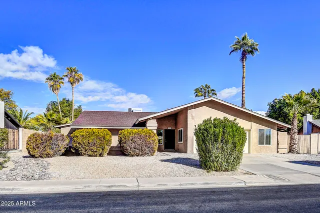 a living room with kitchen furniture and a flat screen tv
