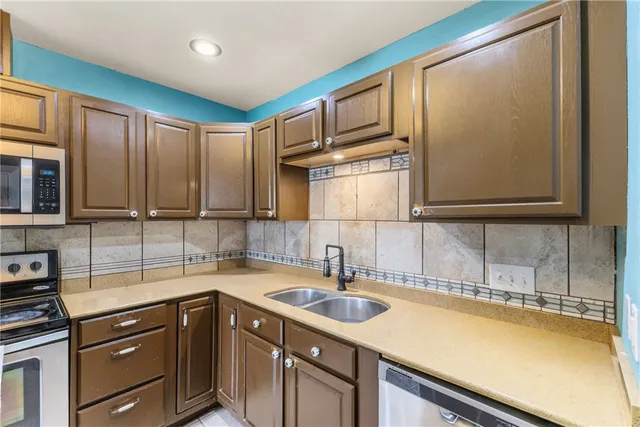 a kitchen with a sink cabinets and stainless steel appliances