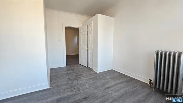 a view of a room with wooden floor