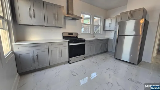 a kitchen with a refrigerator sink and cabinets