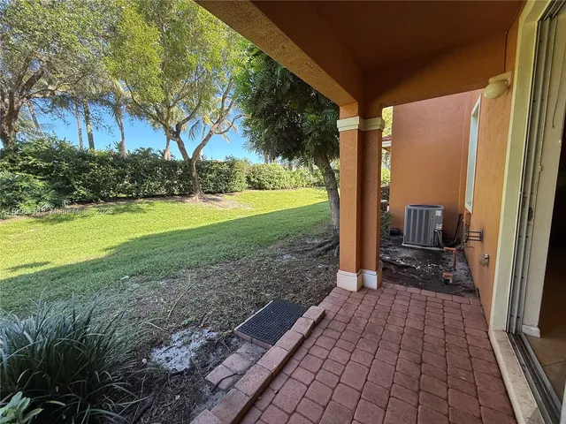a view of a porch with furniture and garden