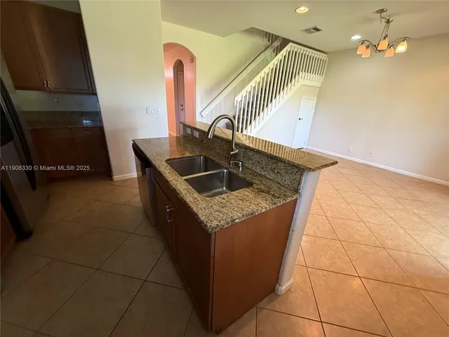 a kitchen with a sink a counter top space and utility