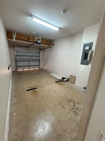 an empty room with a cabinet and mirrors