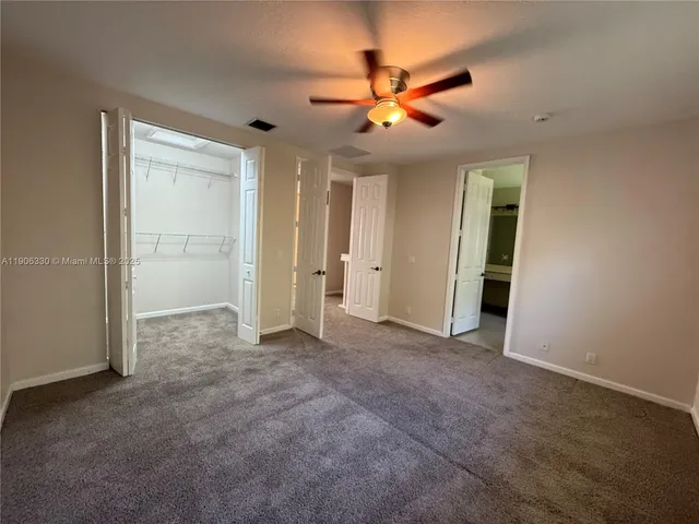 a view of a livingroom with a ceiling fan and window