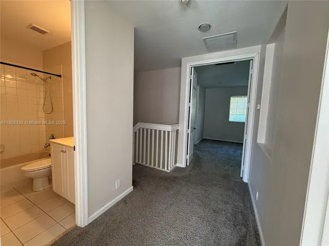 a view of an empty room and a window