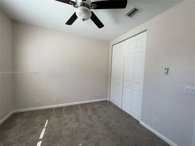 a front view of a house with a garden and lake view