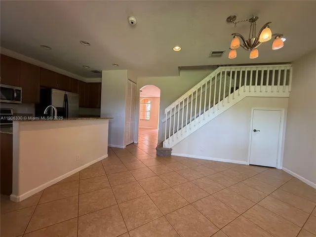 a view of entryway and hall with a front door