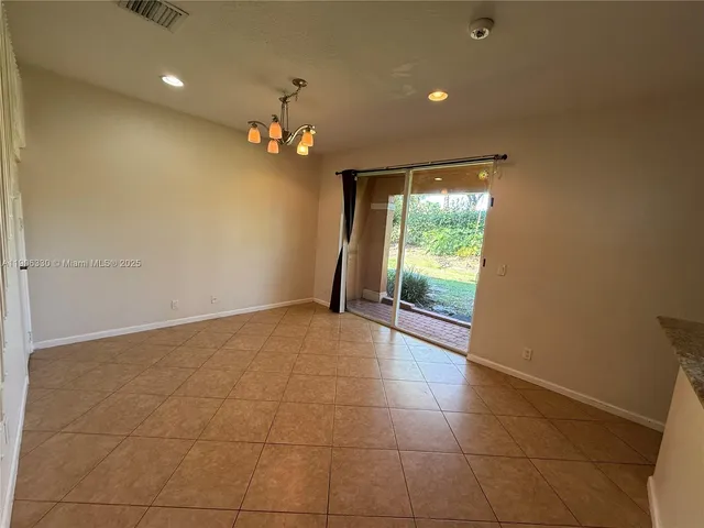 a view of an empty room and a window