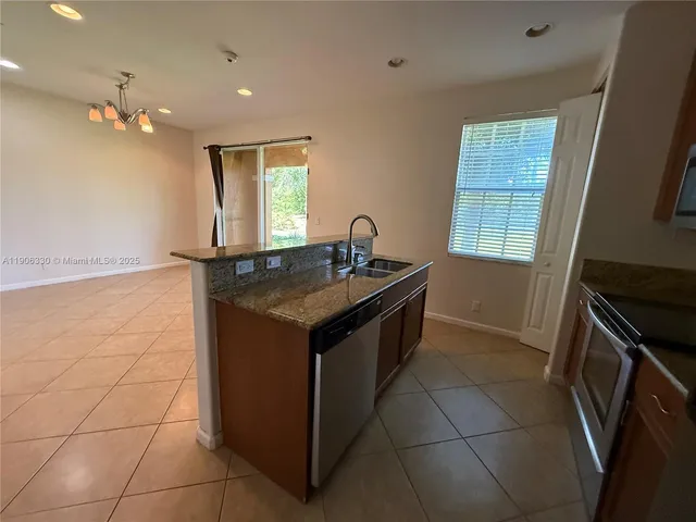 a kitchen with a sink a counter space and a window