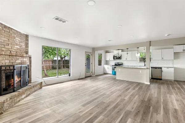 a view of a kitchen with microwave and stove top oven