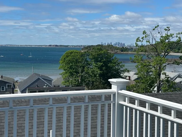 a view of balcony with wooden floor and fence