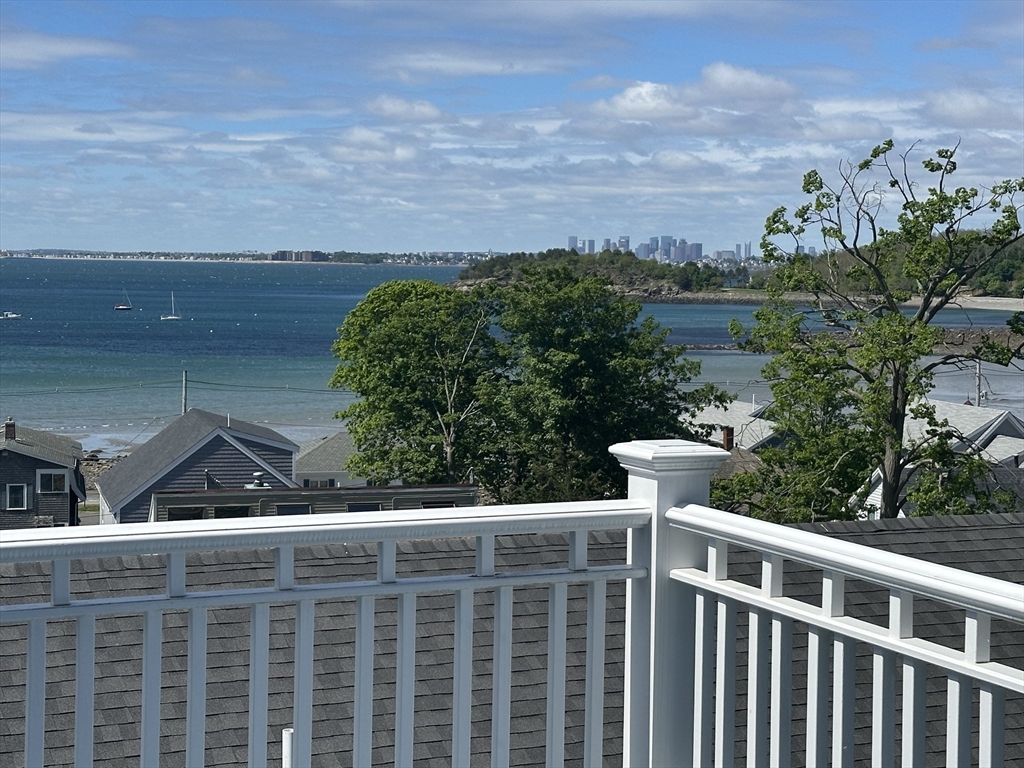 a view of balcony with wooden floor and fence