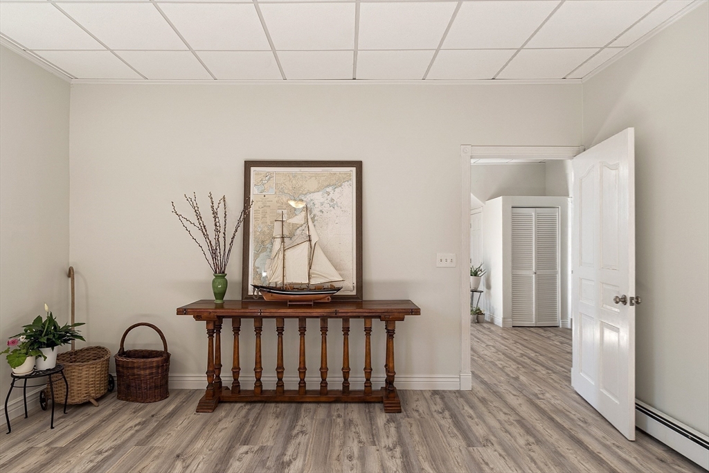 303 Nahant Road Nahant, MA 01908 - Photo 28 of 41 a view of a hallway with wooden floor and furniture