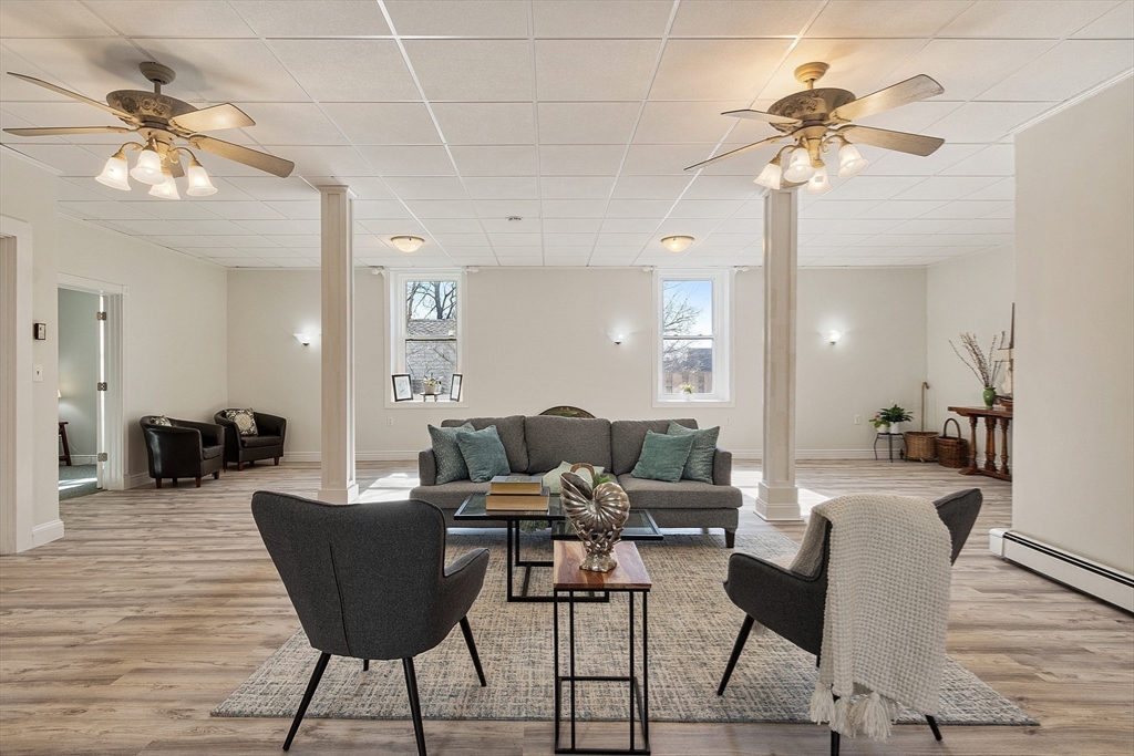 303 Nahant Road Nahant, MA 01908 - Photo 30 of 41 a living room with furniture a chandelier and a wooden floor