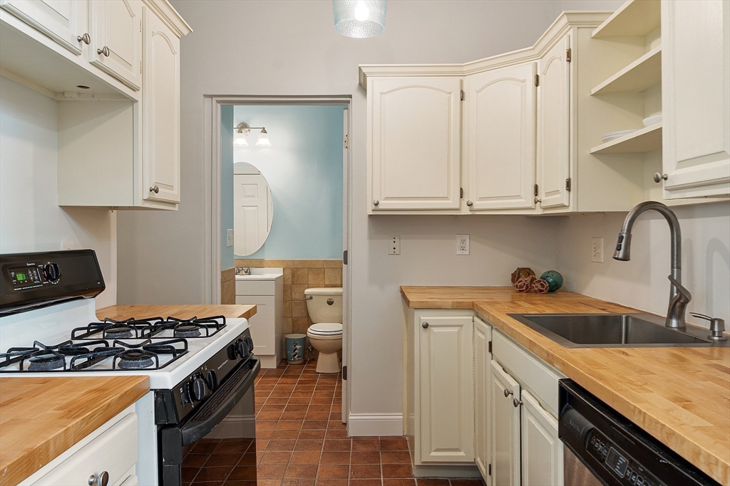 303 Nahant Road Nahant, MA 01908 - Photo 32 of 41 a kitchen with a sink stove top oven and cabinets