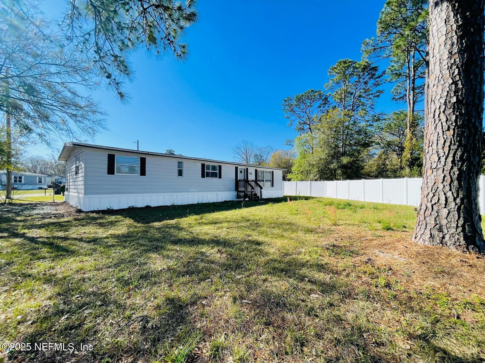 8660 Maynard Place Jacksonville, FL 32222 - Photo 14 of 14 a view of a backyard with a house