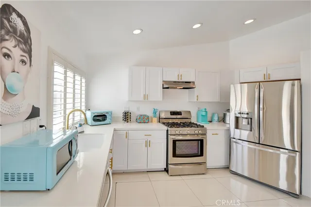 a kitchen with a white stove top oven and refrigerator