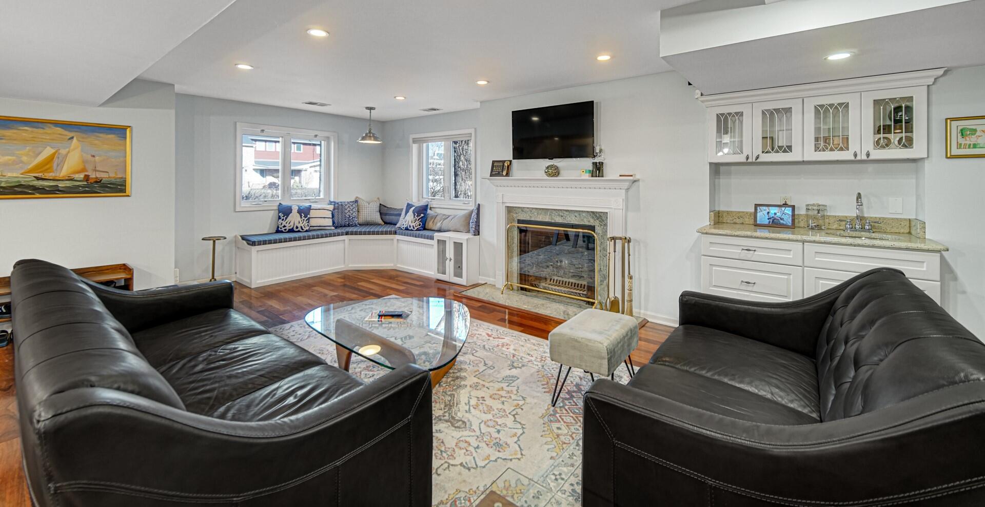 131 Shore Drive Portage, IN 46368 - Photo 16 of 30 a living room with furniture a flat screen tv and a fireplace