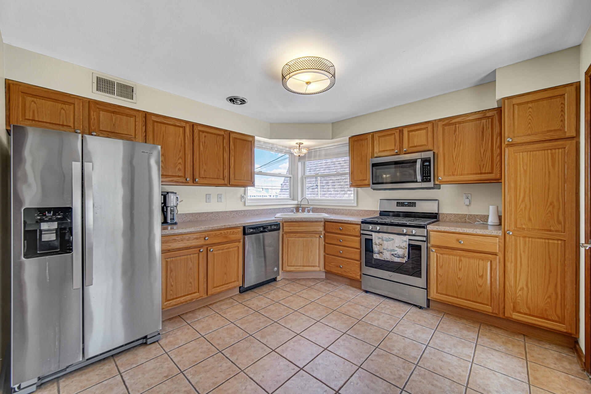 131 Shore Drive Portage, IN 46368 - Photo 9 of 30 a kitchen with stainless steel appliances granite countertop a refrigerator sink and stove