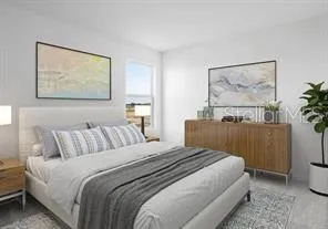 a bedroom with a bed and a painting on the wall